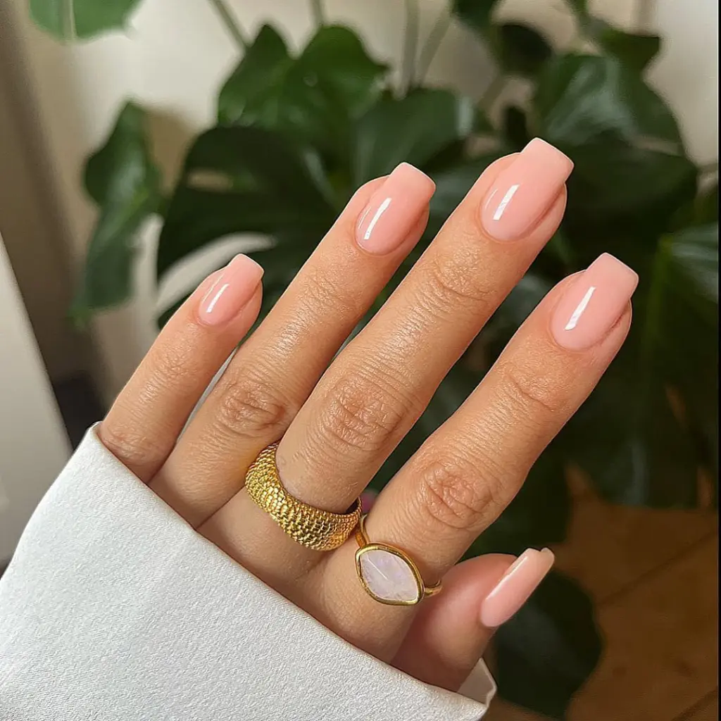 Peachy nude neutral nails with high gloss finish on square shape
