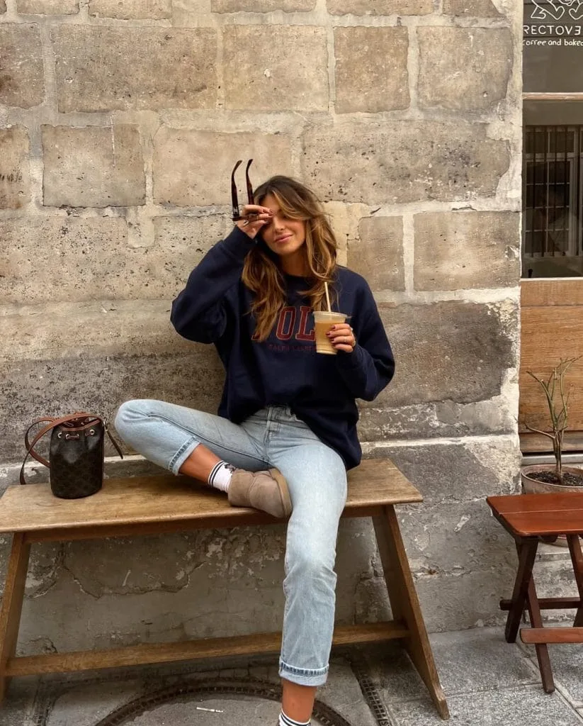 Casual fall outfit with navy oversized sweatshirt, light wash cropped jeans, tan ankle boots
