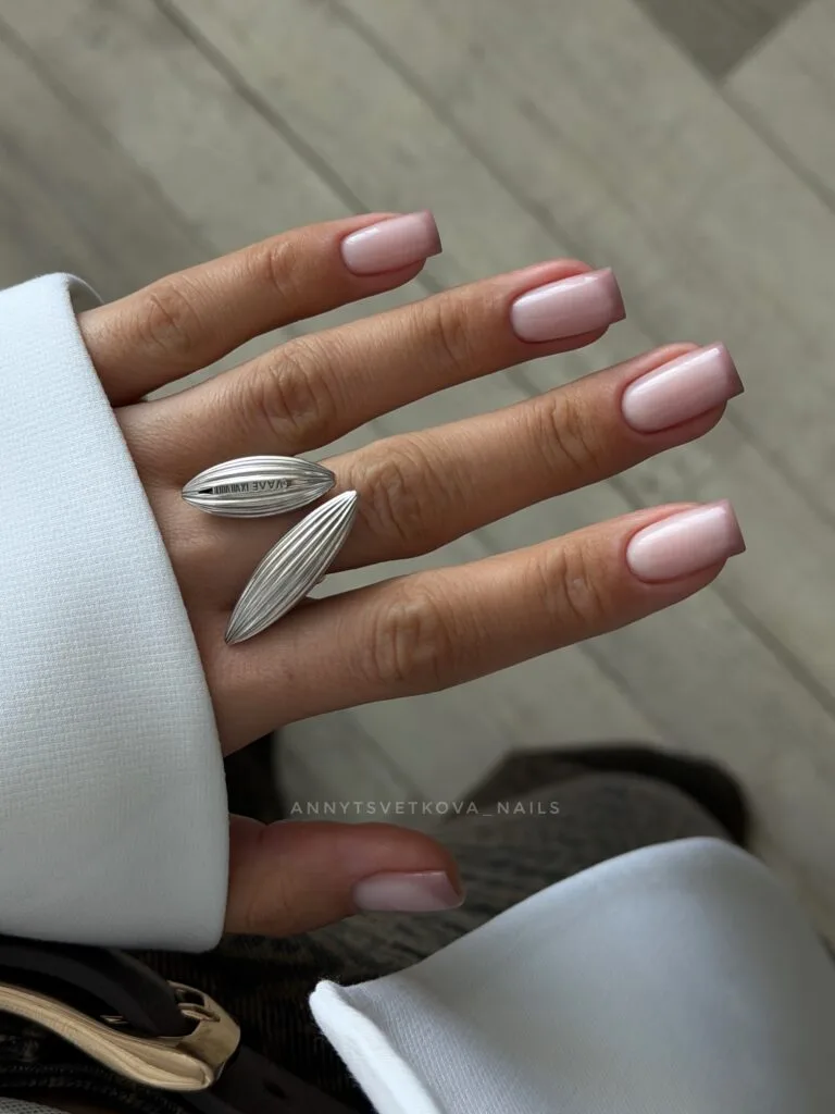 Square nails with a milky pink base and subtle pale French tips.