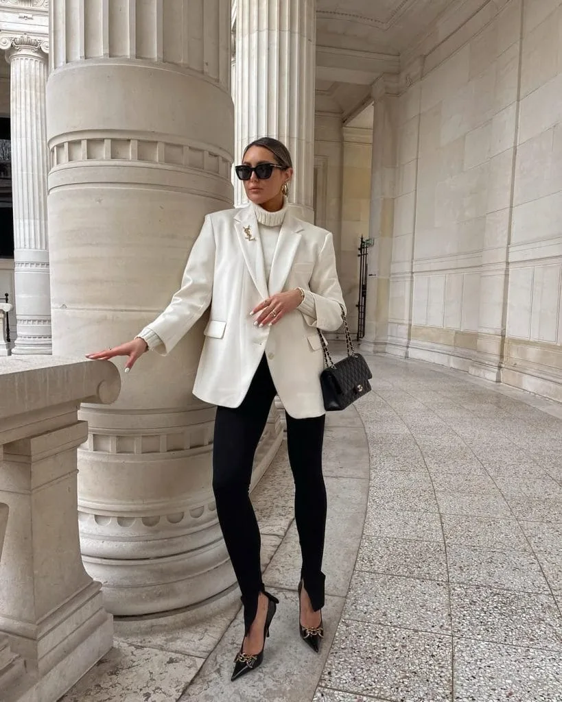 Classic old money outfit with cream blazer, turtleneck, black leggings and quilted bag