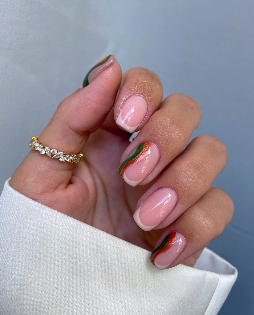 Short fall French tip nails with green and orange stripes on nude base
