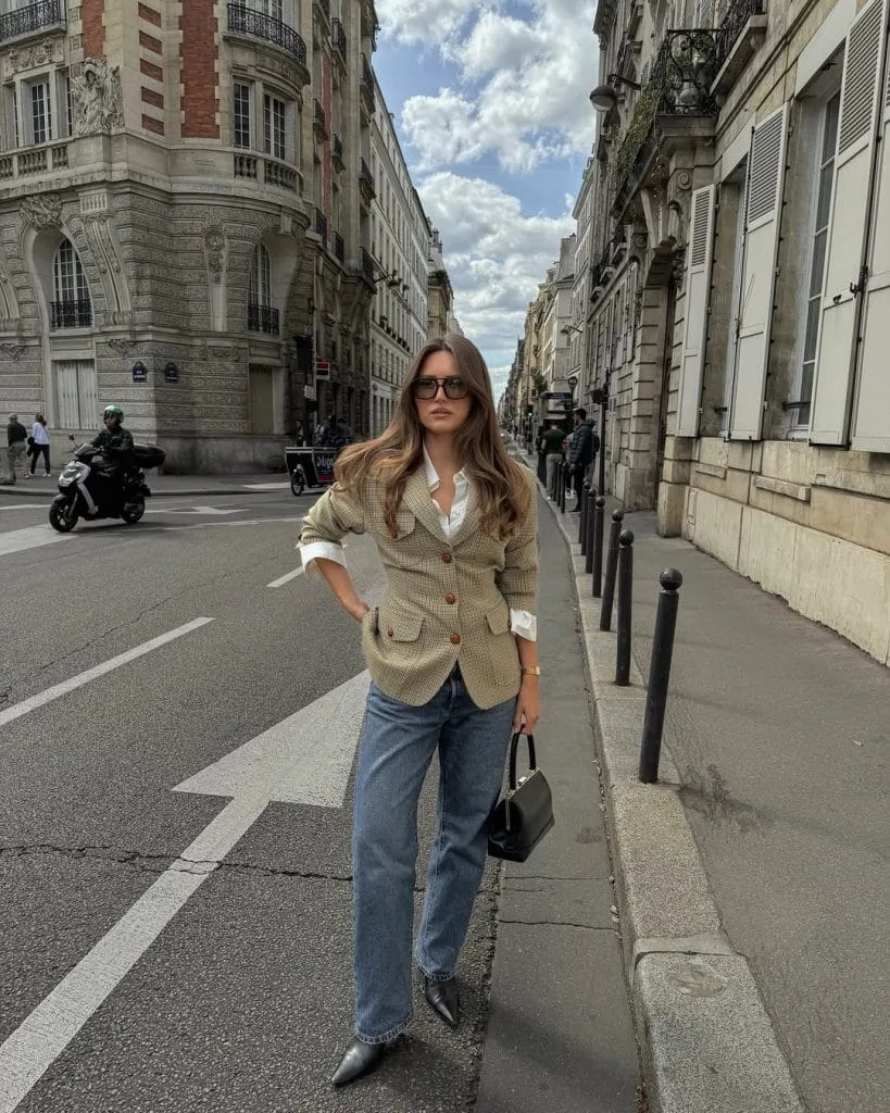 Old money fall outfit with plaid blazer, white shirt, straight jeans and black accessories