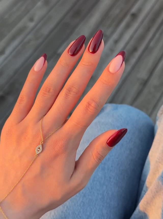 Glossy almond fall nails alternating solid burgundy with burgundy French tips over pink bases.