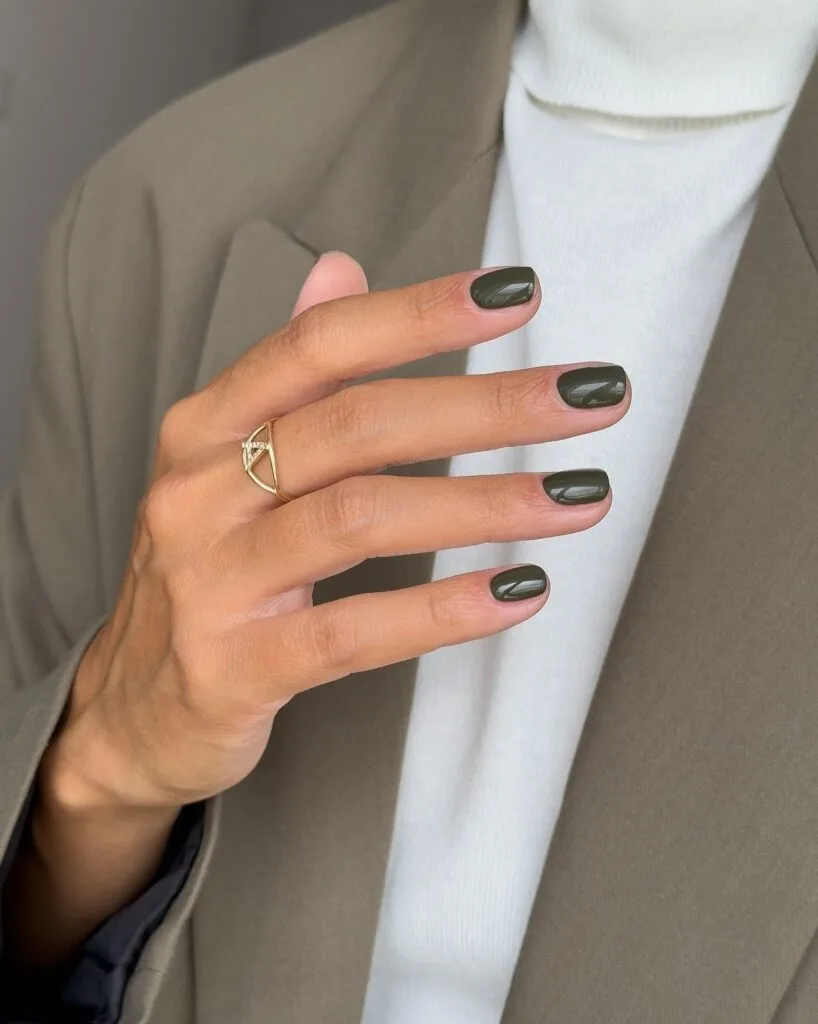Short, softly squared old money fall nails in glossy dark olive green.
