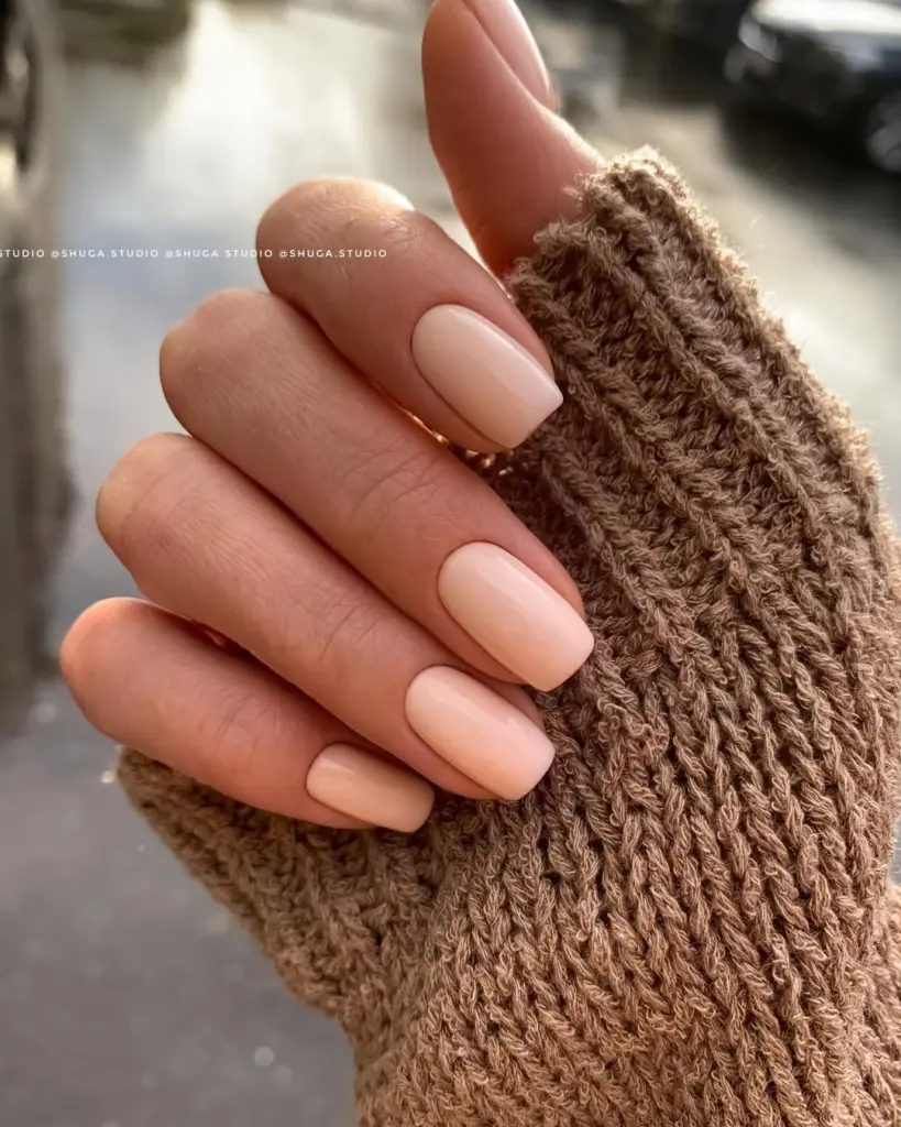 Short fall nails in warm peachy nude shade with matte finish and square shape