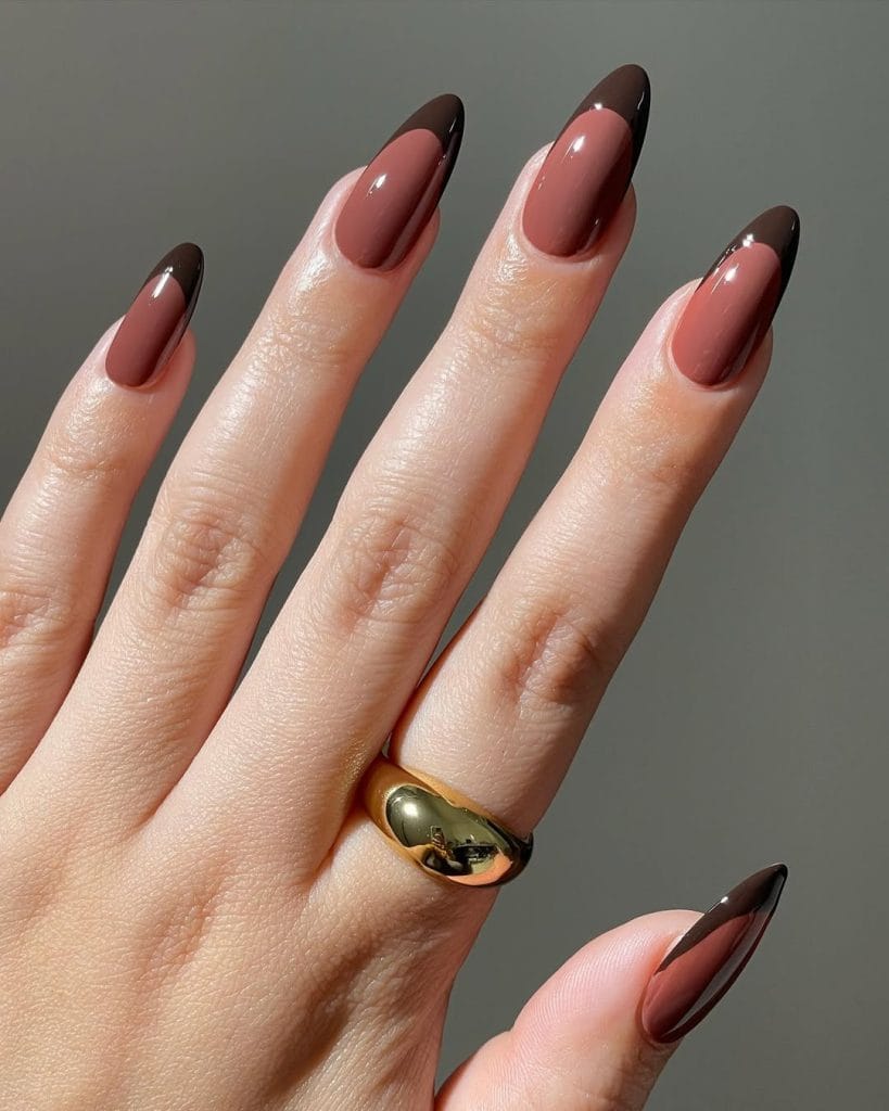 Chocolate brown fall French tip nails on long almond nails with tonal brown base