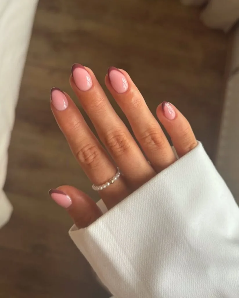 Elegant oval nails with glossy pink bases and curved rosy-brown French tips.