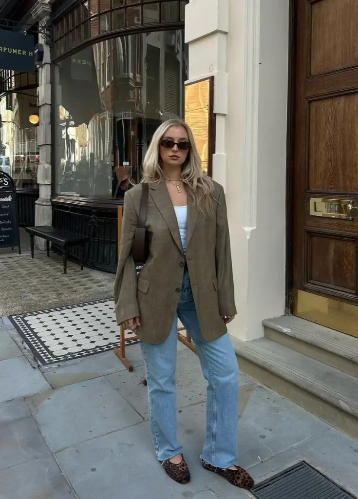Effortless fall outfit with olive oversized blazer, white t-shirt, straight-leg jeans, leopard print flats and black shoulder bag
