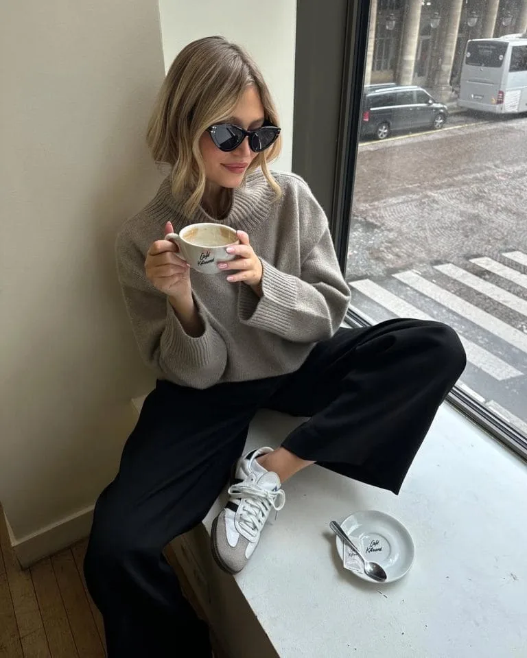 Casual fall outfit with taupe oversized turtleneck sweater, black wide-leg pants, white sneakers