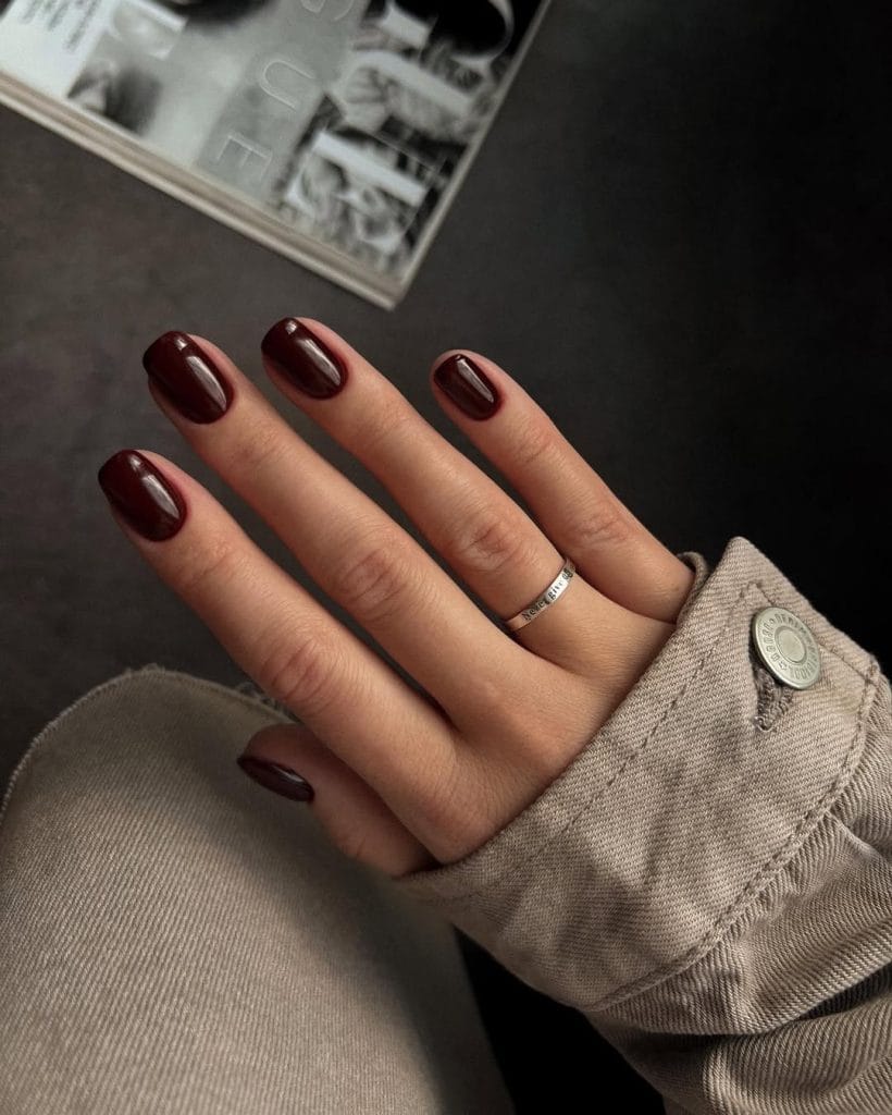 Short round September nails with dark chocolate brown polish