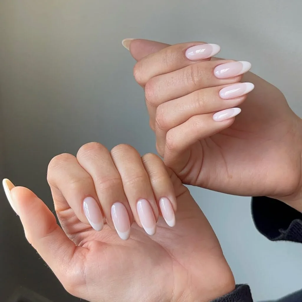 neutral nails in milky white almond shape with classic French tips glossy finish