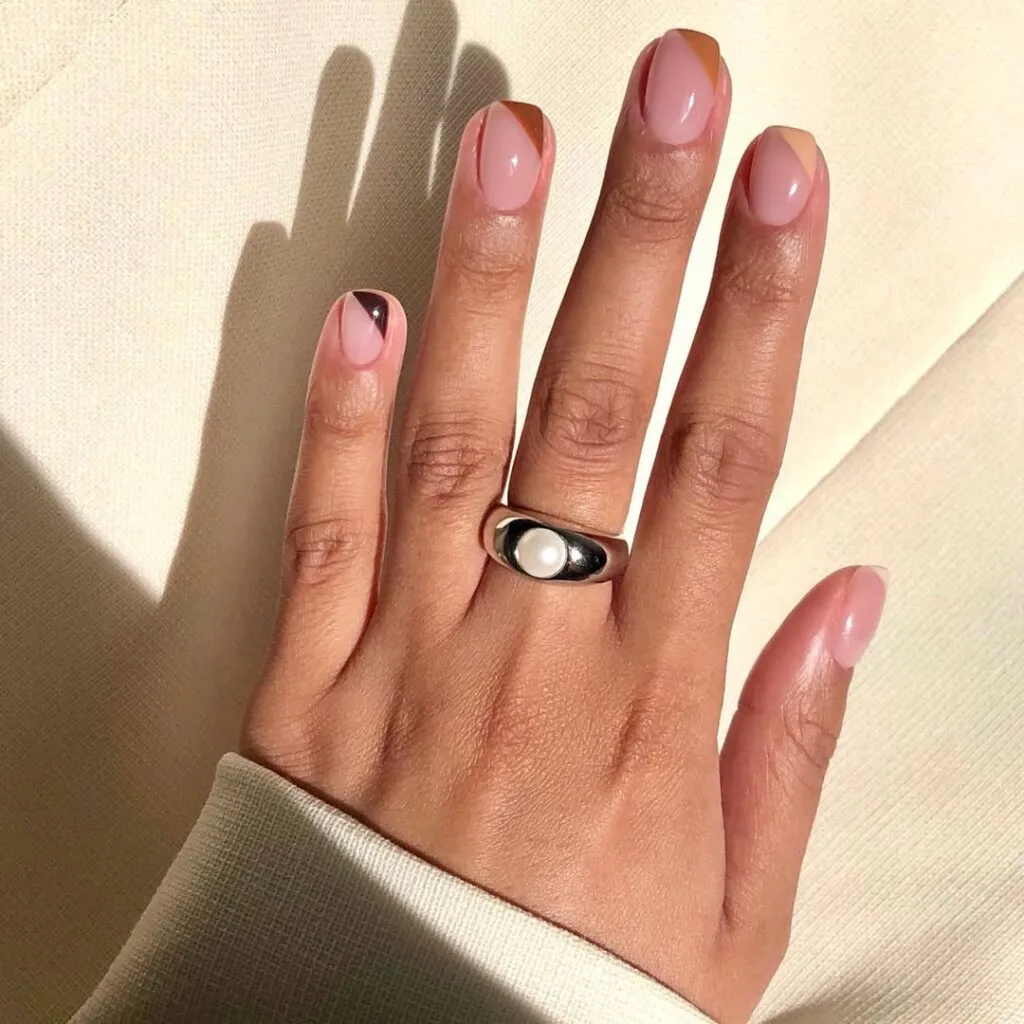 neutral nails with abstract angular brown French tips on glossy nude pink short square shape