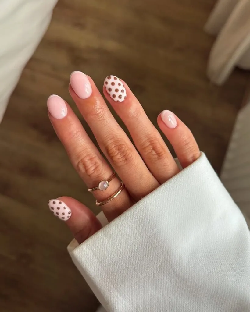 neutral nails with chocolate polka dot accents and nude French tips on short oval shape
