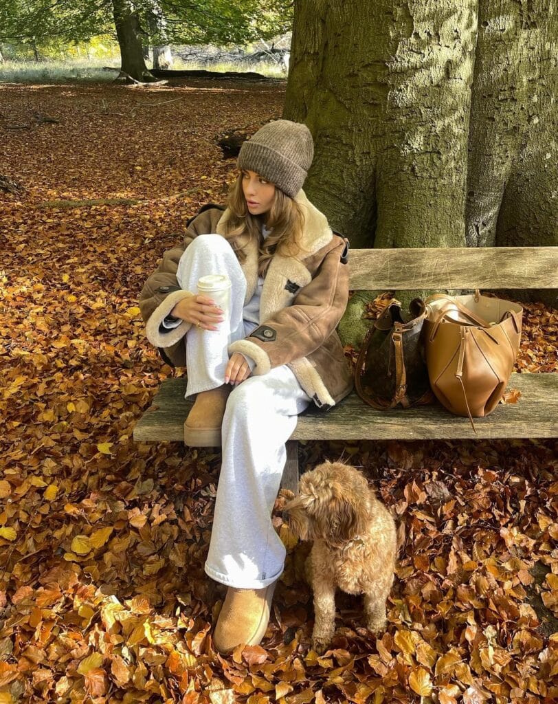 Cozy fall outfit with tan shearling jacket over white sweatsuit, gray ribbed beanie and tan Ugg boots

