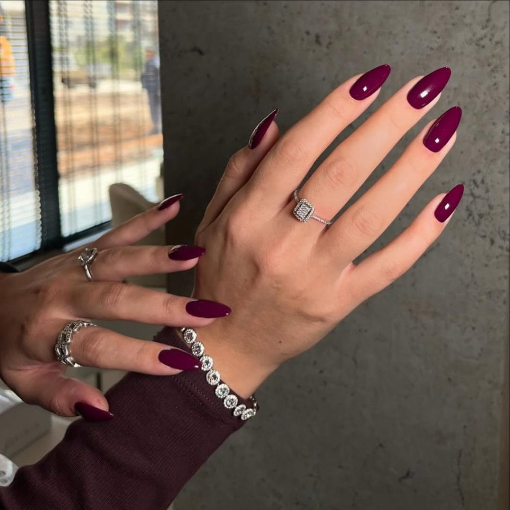 Long almond old money fall nails in deep plum purple with diamond jewelry