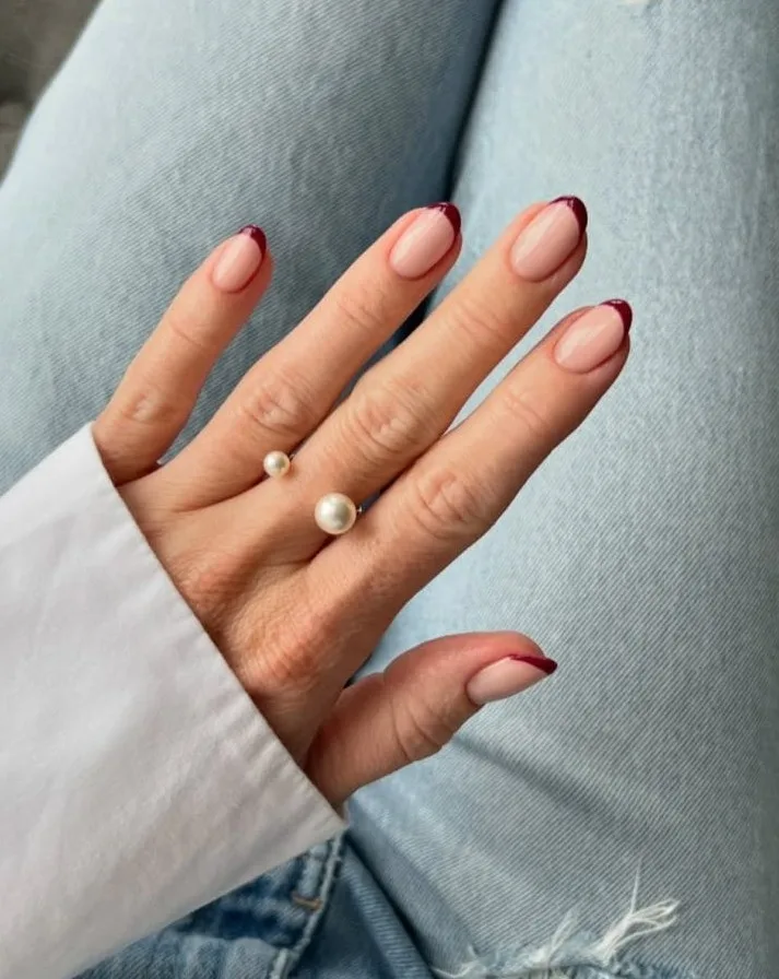 Short oval old money fall nails with nude base and burgundy French tips