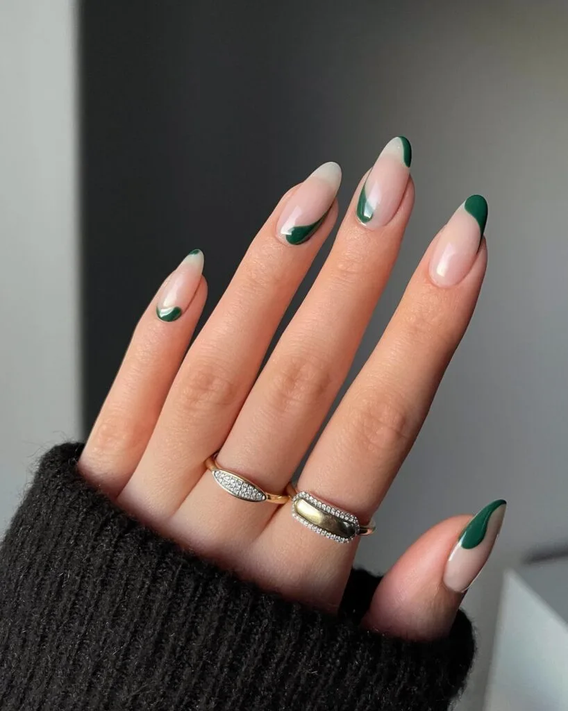 Nude almond nails with dark green curved French tips