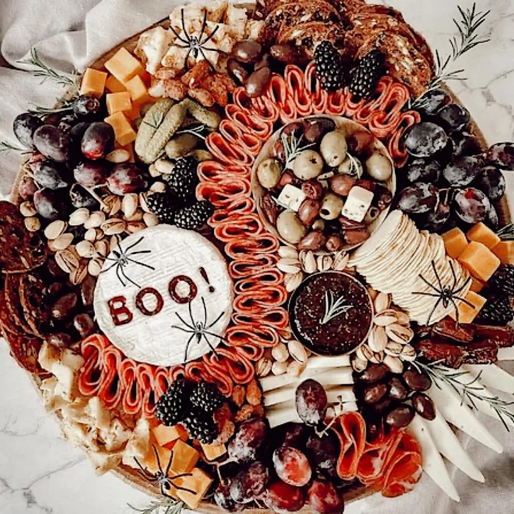 Halloween charcuterie board with BOO brie message