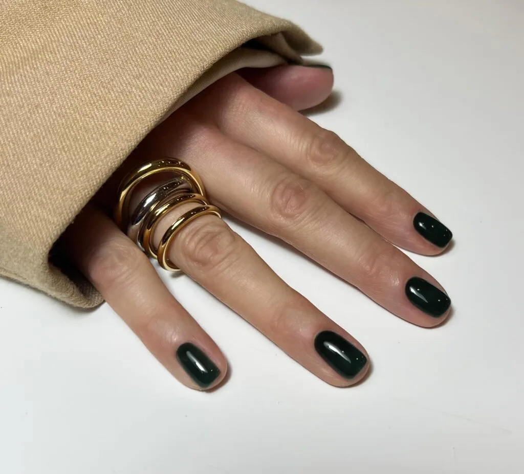 Short glossy dark green nails with minimalist chic style
