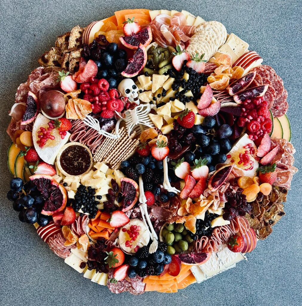 Halloween charcuterie board with white skeleton centerpiece