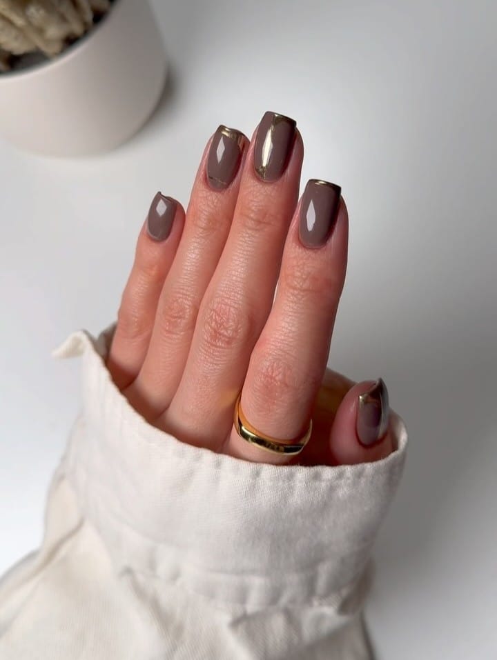 short nails with taupe polish and gold French tips, October nail design