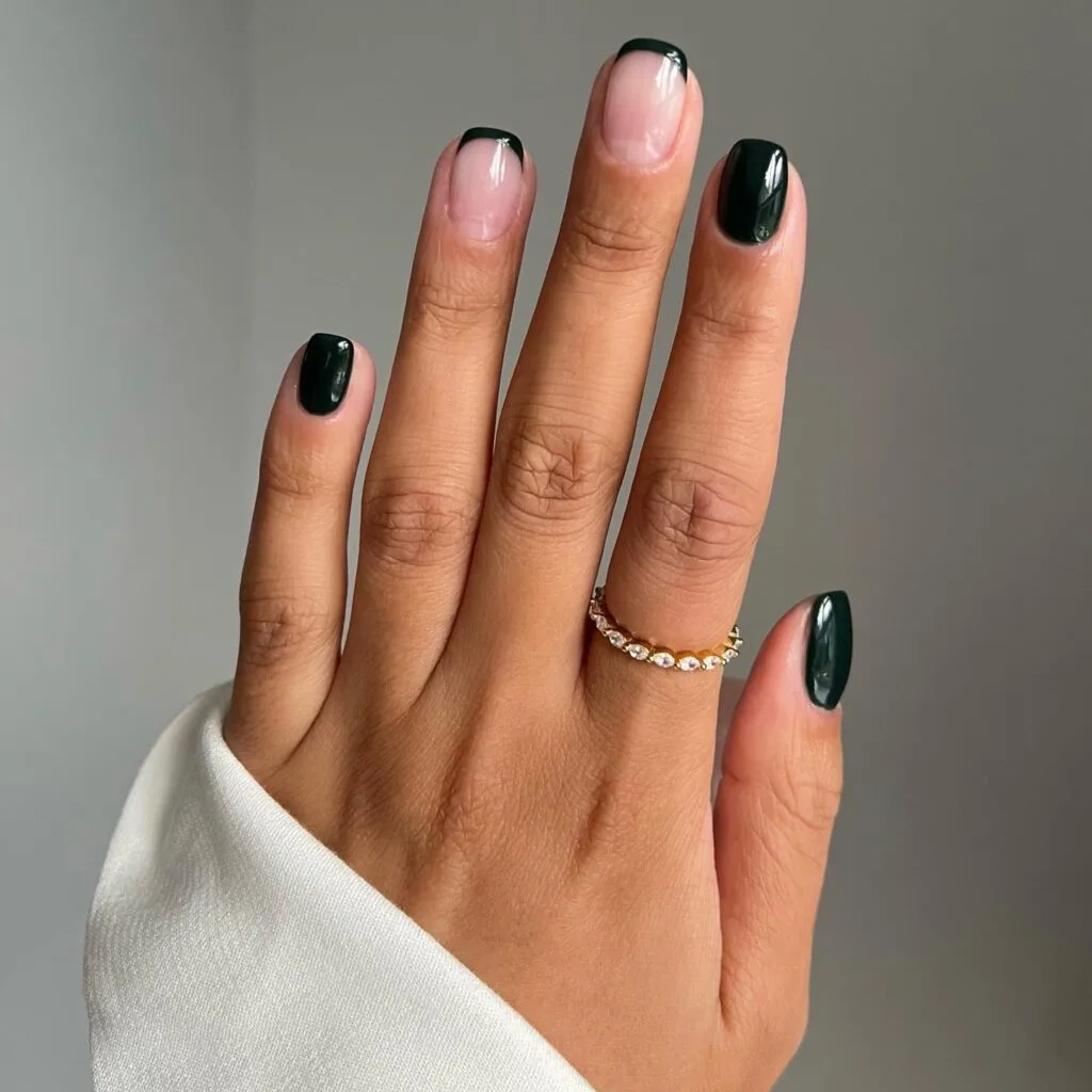 Dark green manicure with mix of solid nails and French tips