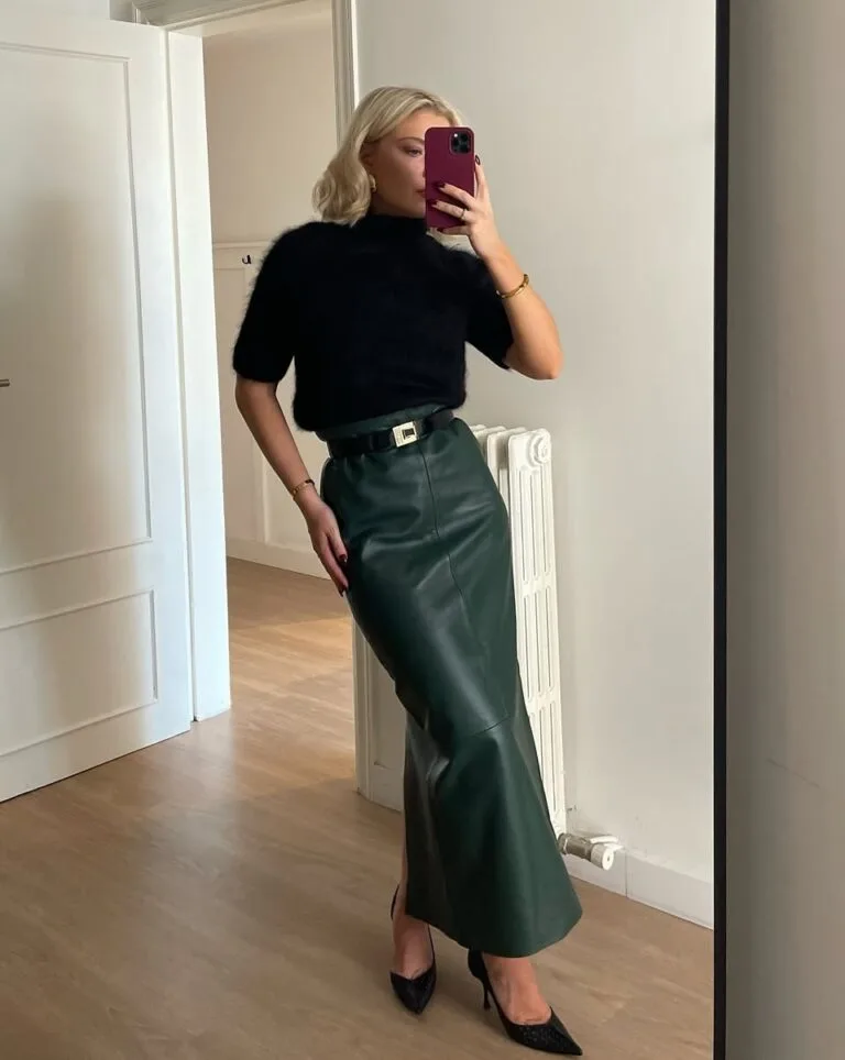 Black short-sleeve sweater with green leather maxi skirt for elegant fall date night outfit