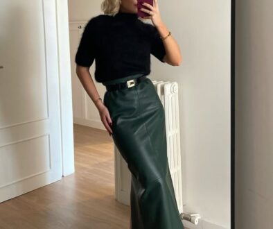 Black short-sleeve sweater with green leather maxi skirt for elegant fall date night outfit
