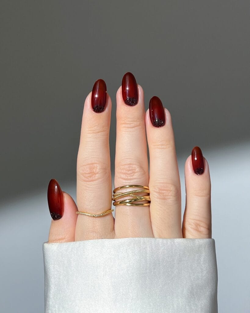 almond nails with burgundy polish fading into black glitter cuticle detail, October nails