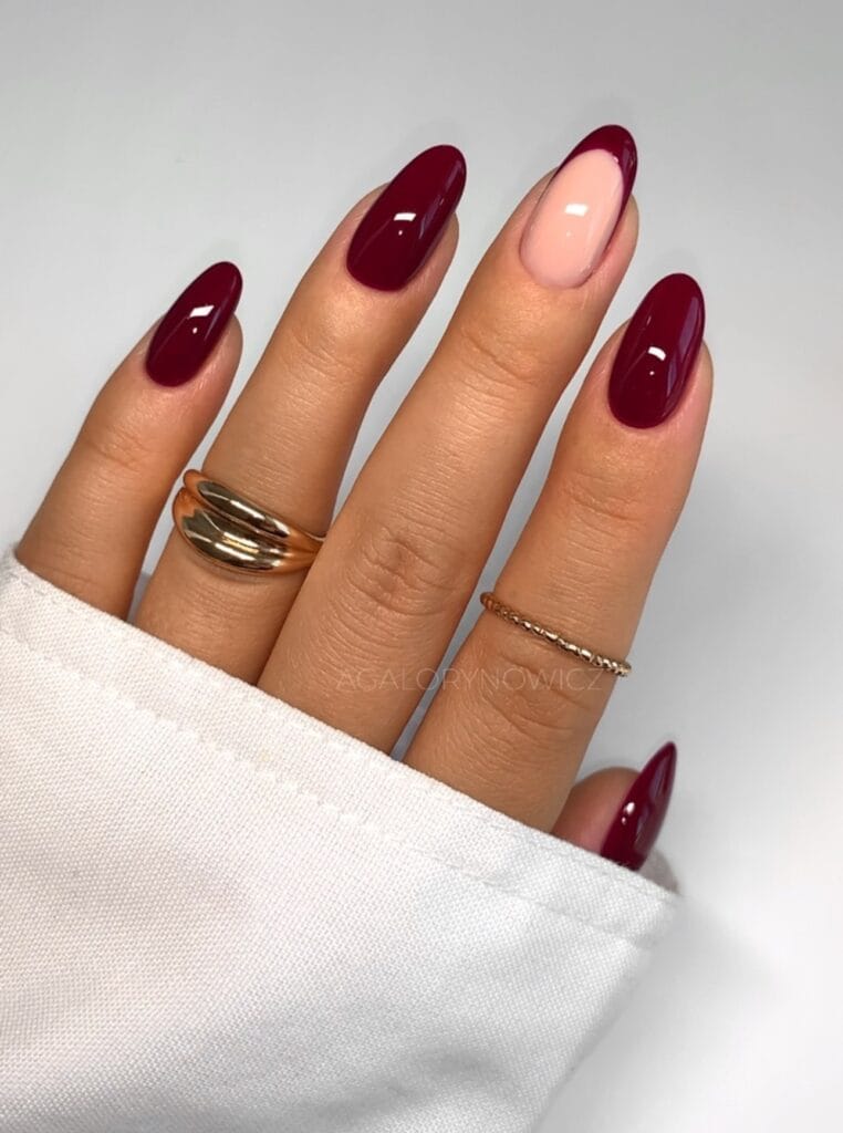 Burgundy almond nails with nude accent French design