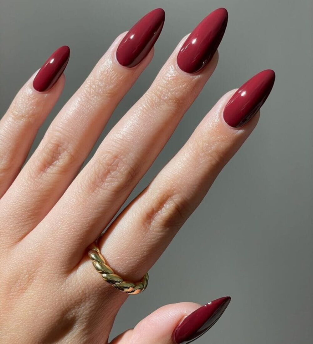almond-shaped nails in glossy cherry mocha fall nail color
