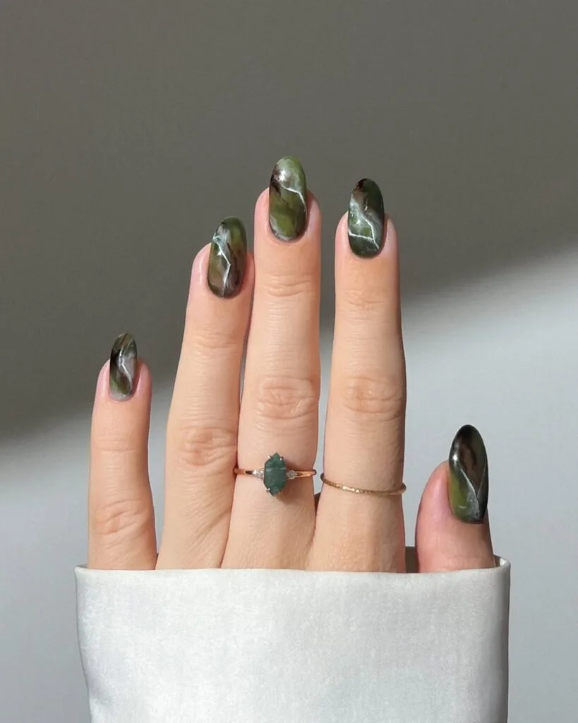 Dark green marble nails with gemstone-like swirl effect