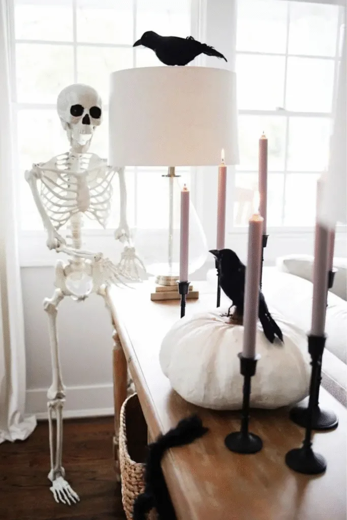 Skeleton Halloween decorations with ravens and pink candles