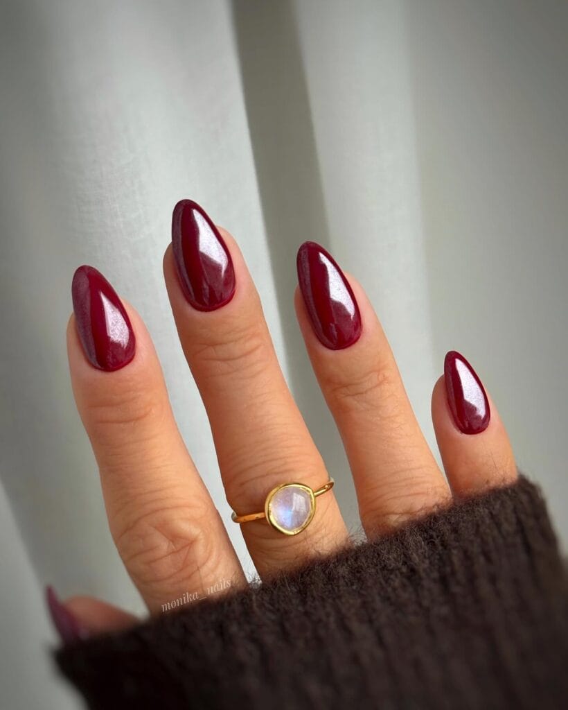 Burgundy chrome almond nails with metallic shimmer finish