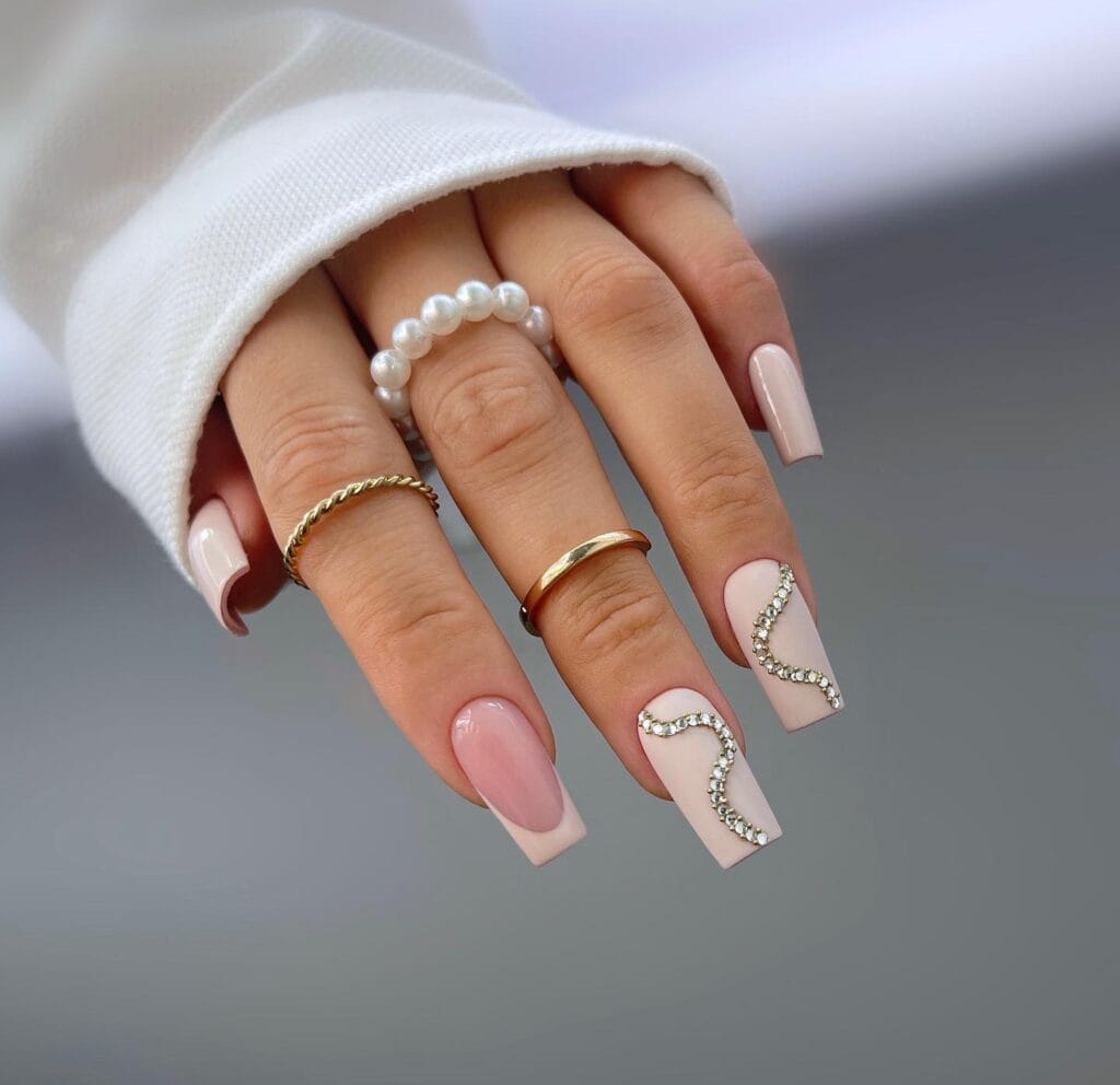 long square cream nails with rhinestone wave accents, Halloween glam nail art
