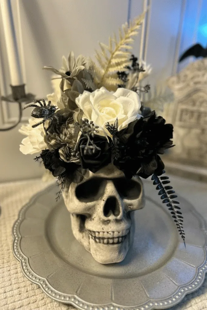 Skull vase Halloween decor with black and white flowers