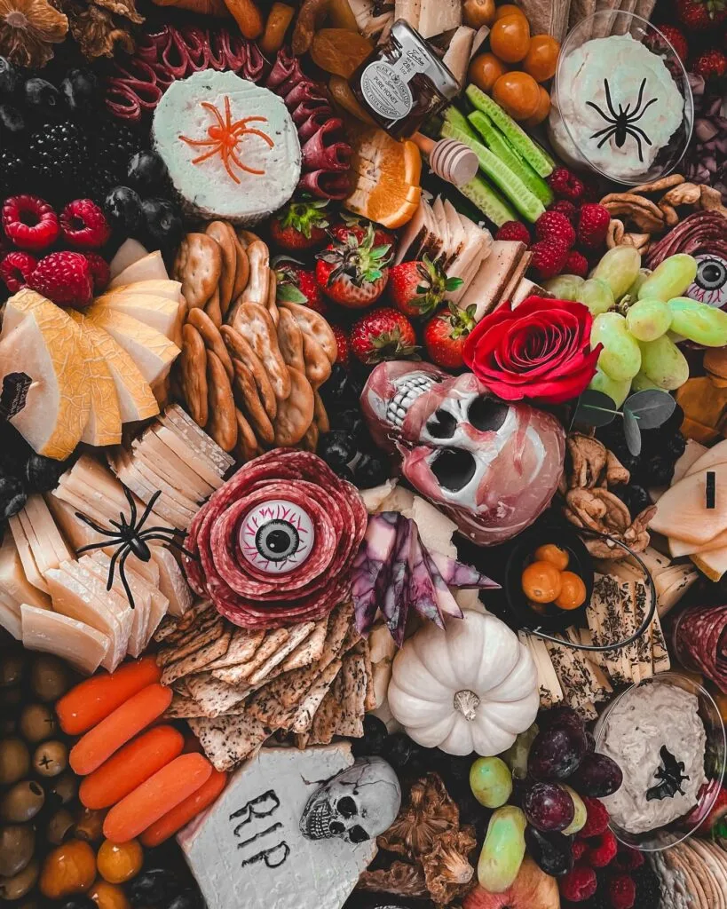 Halloween charcuterie board with salami eye and tombstone