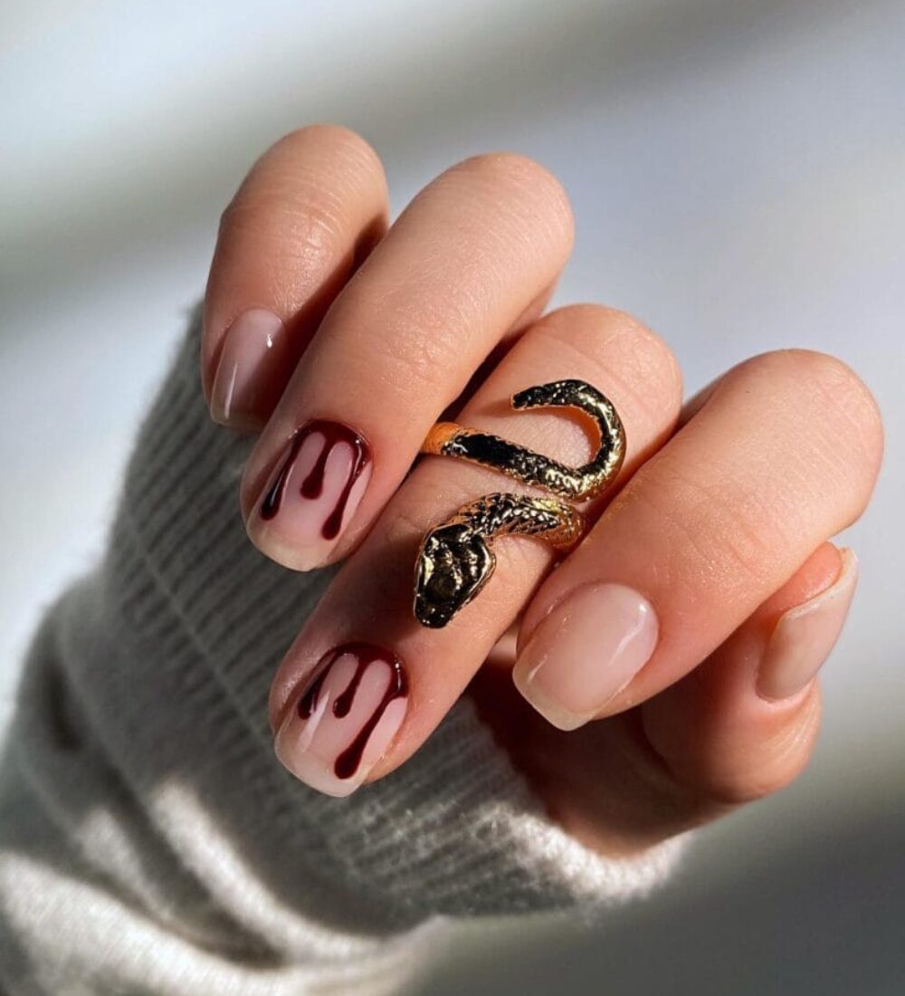 Nude short Halloween nails with blood-red drip nail art and snake ring