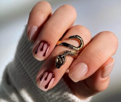 Nude short Halloween nails with blood-red drip nail art and snake ring