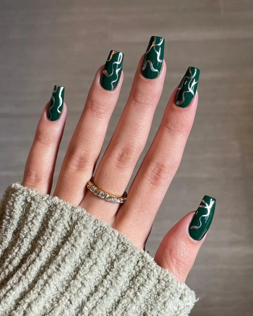 Dark green coffin nails with metallic gold wave nail art