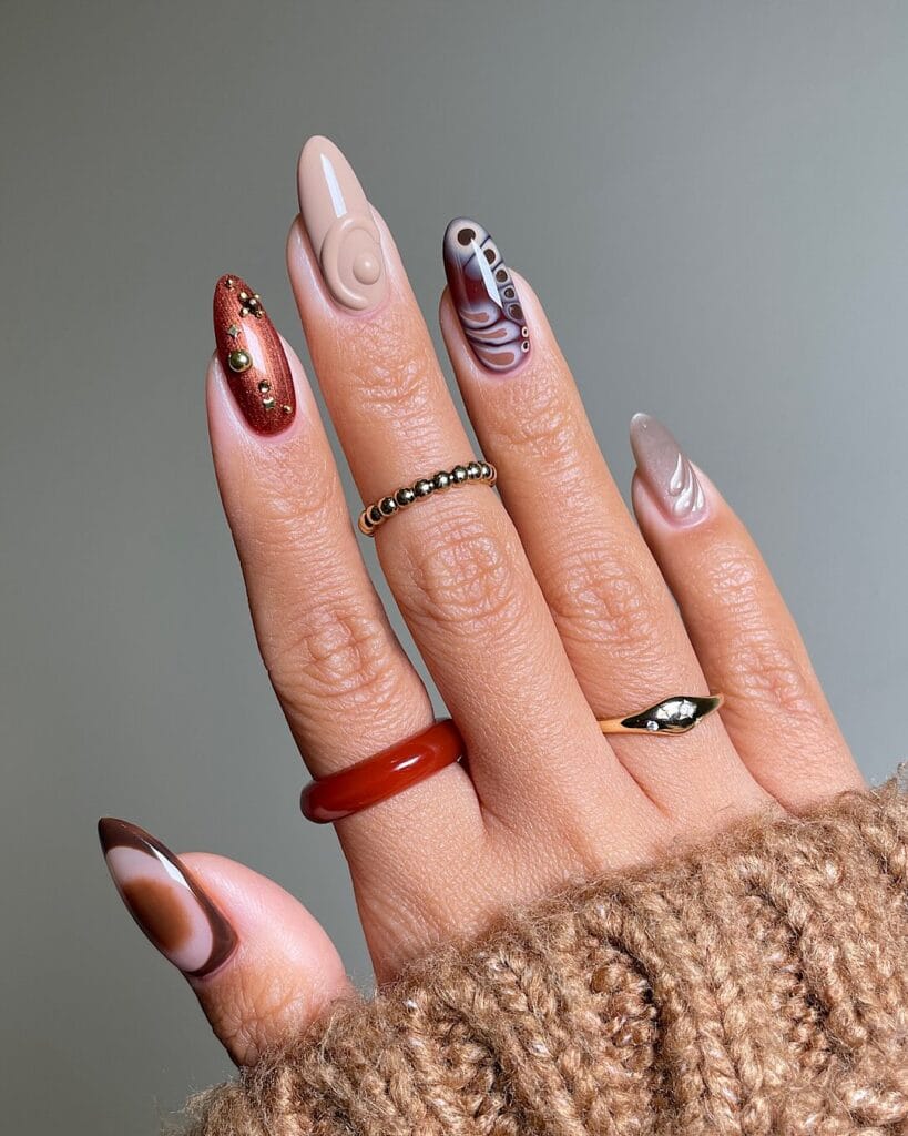 almond nails with mixed fall designs including snake print, copper glitter, and 3D swirls, October nail art