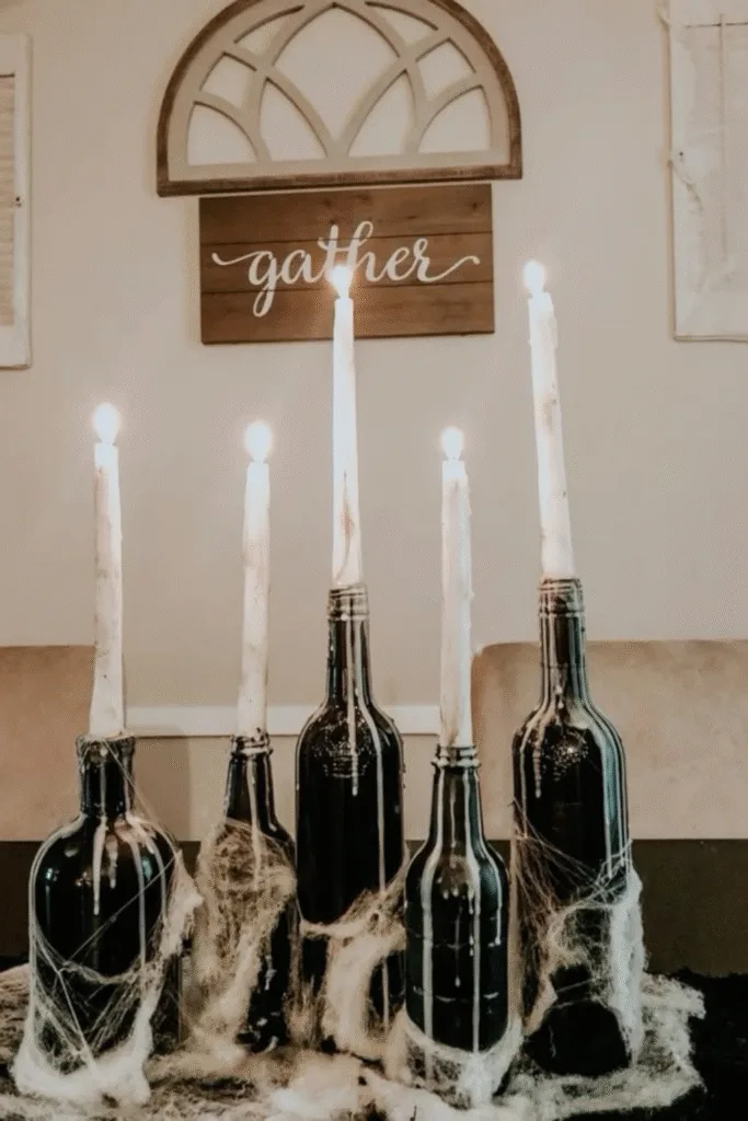 Halloween decor ideas with black wine bottles and candles