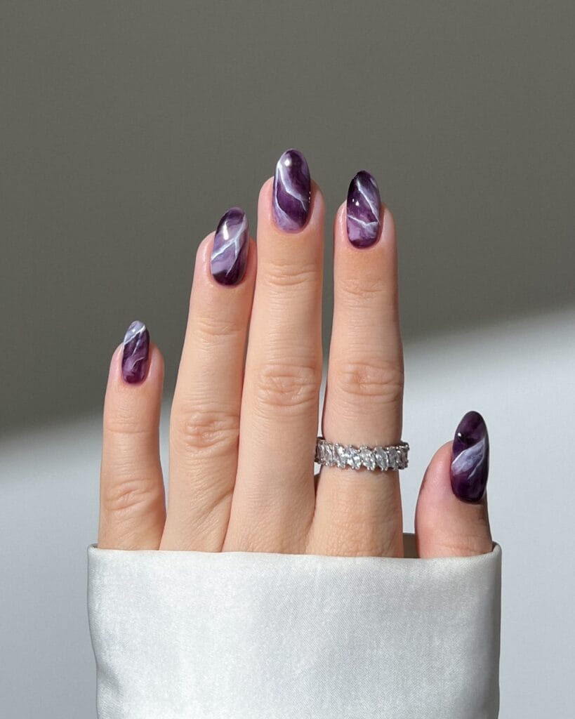 almond nails with purple marble design and white streaks, Halloween nail ideas