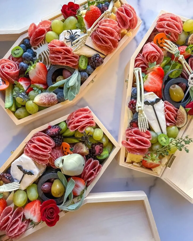 Halloween charcuterie board in coffin-shaped boxes
