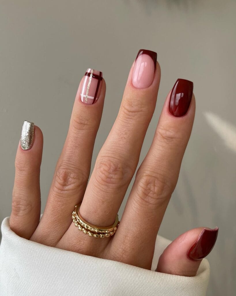 Burgundy plaid nail design with silver glitter accent