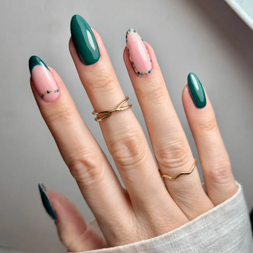 Dark green French tip and accent nail with gold and green dotted outline
