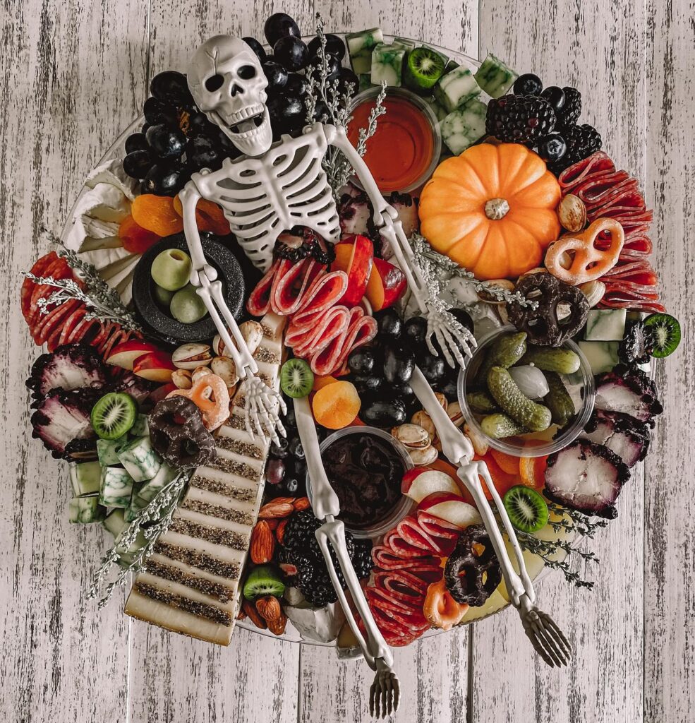 Halloween charcuterie board with skeleton centerpiece