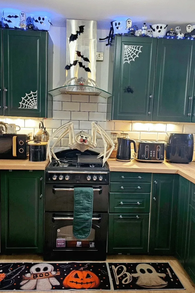 Halloween decorations in kitchen with skeleton spider and ghosts