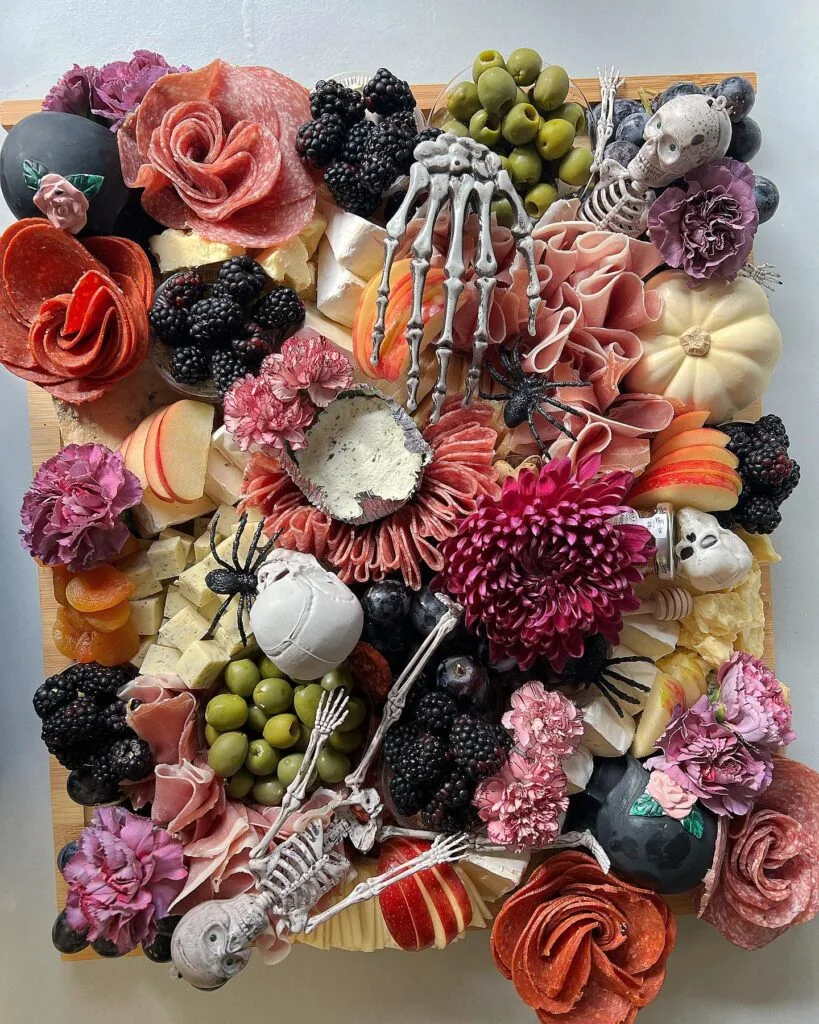 Halloween charcuterie board with skeleton centerpiece
