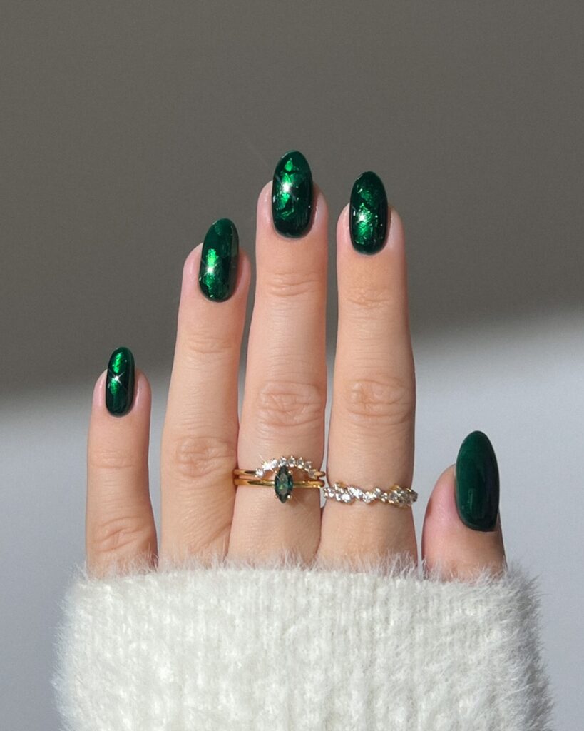 Dark green oval nails with shimmering emerald foil effect